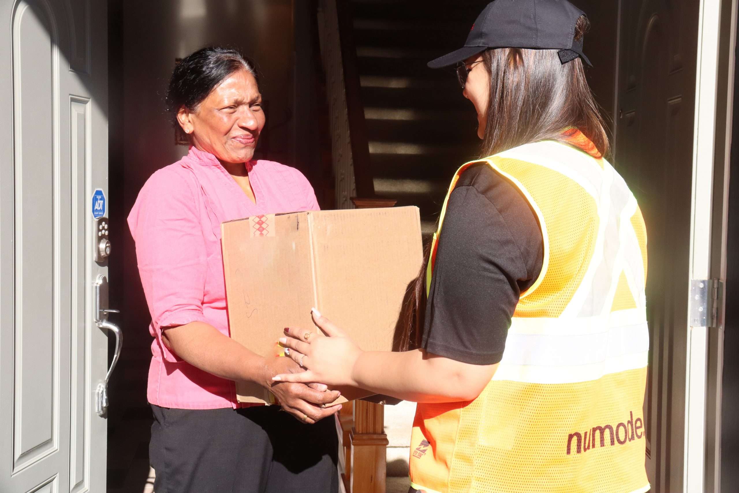 Numode Courier delivering a box to a local customer