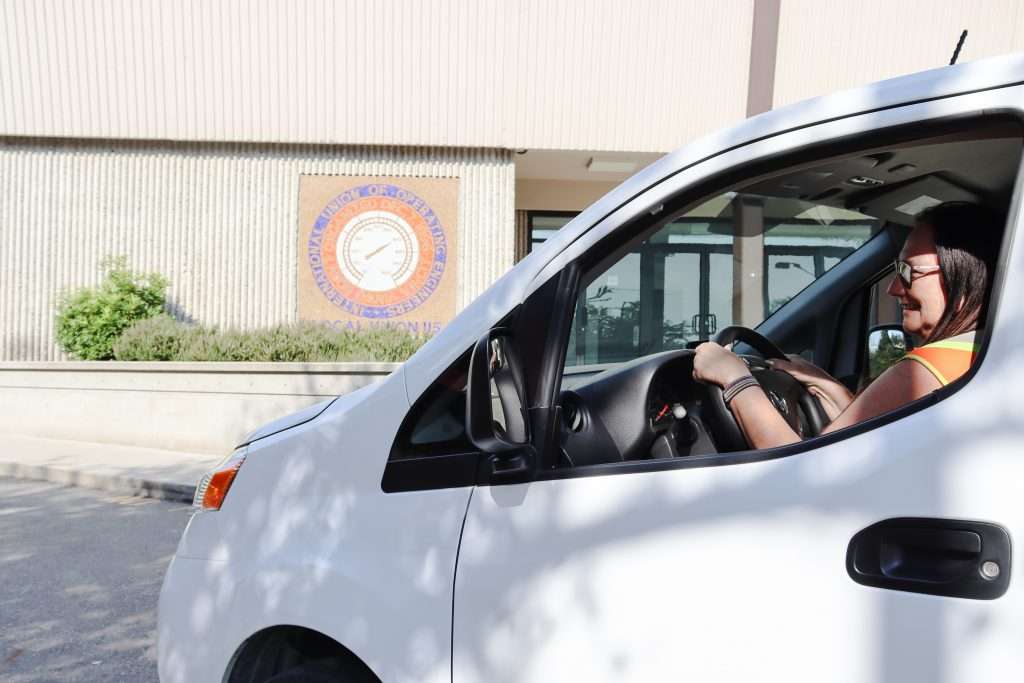 Numode employee driving a company car doing deliveries