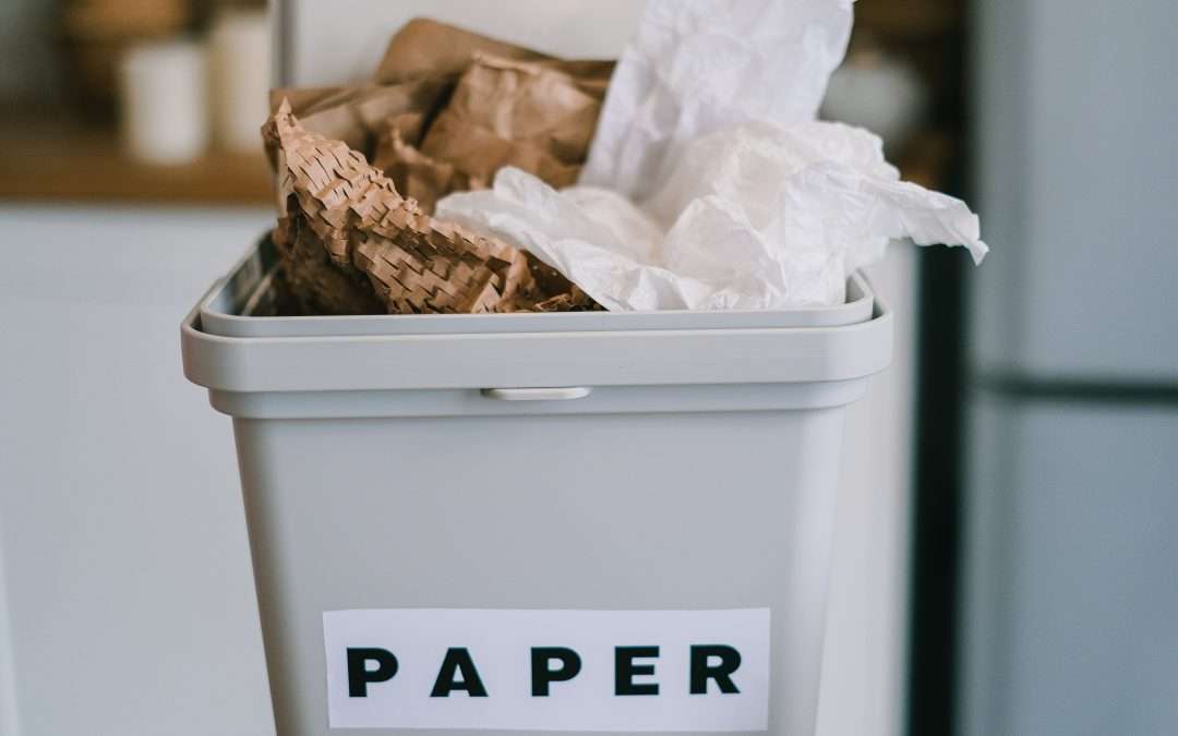 Picture of a full paper trash bin which includes environmentally friendly packaging